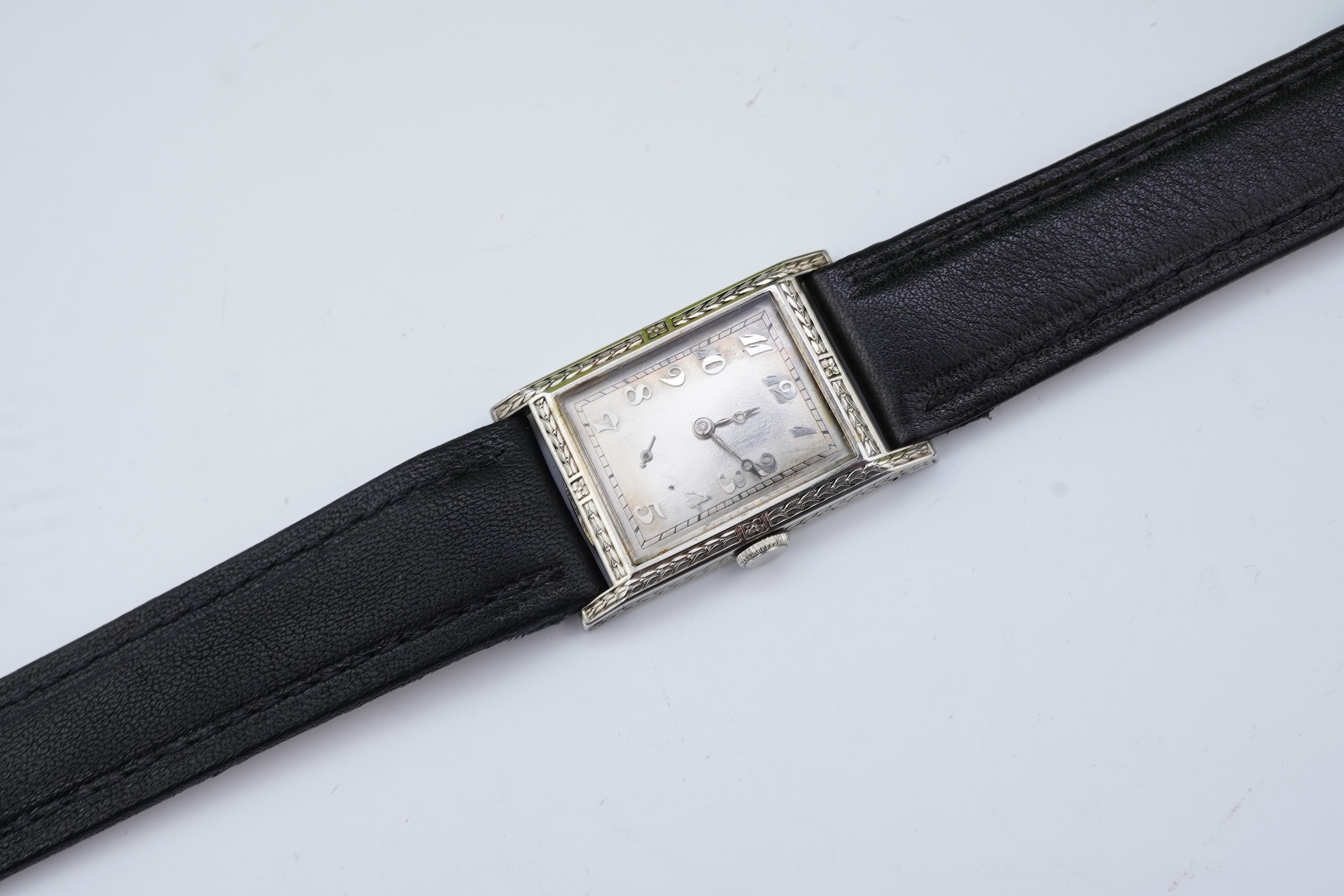 A lady's 18k white gold International Watch Company manual wind wrist watch, on a later associated leather strap